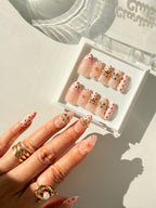Pink Bangle premier gel press on nails close up — dot detail, bangle and gemstone embellishment