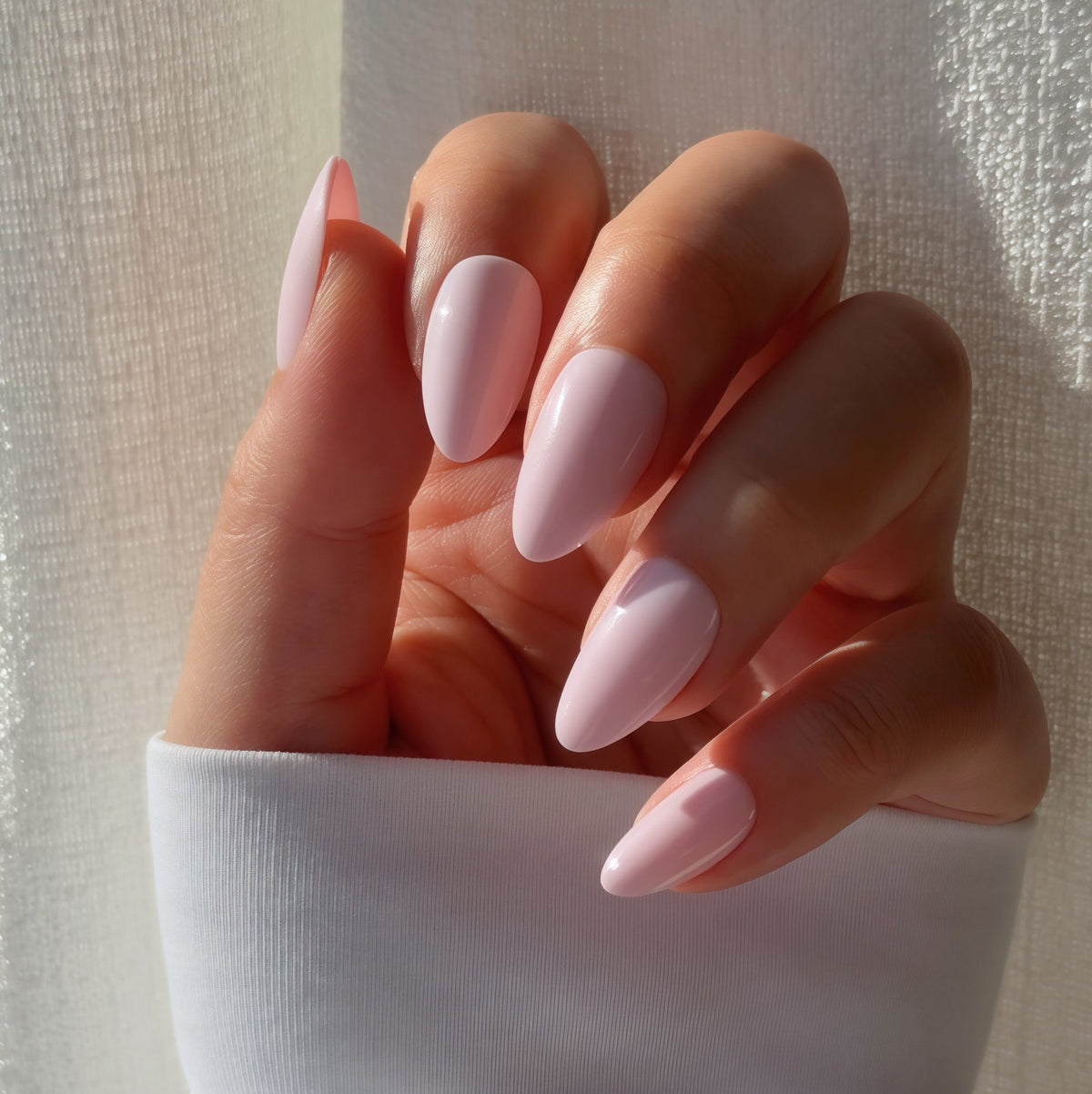Baby Pink short almond soft acrylic press-on nails worn on hand, Clarity Club NZ