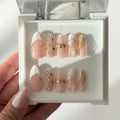Coromandel Gem handmade press-on nails NZ, sheer pink almond with gold seashell, pearls and gems