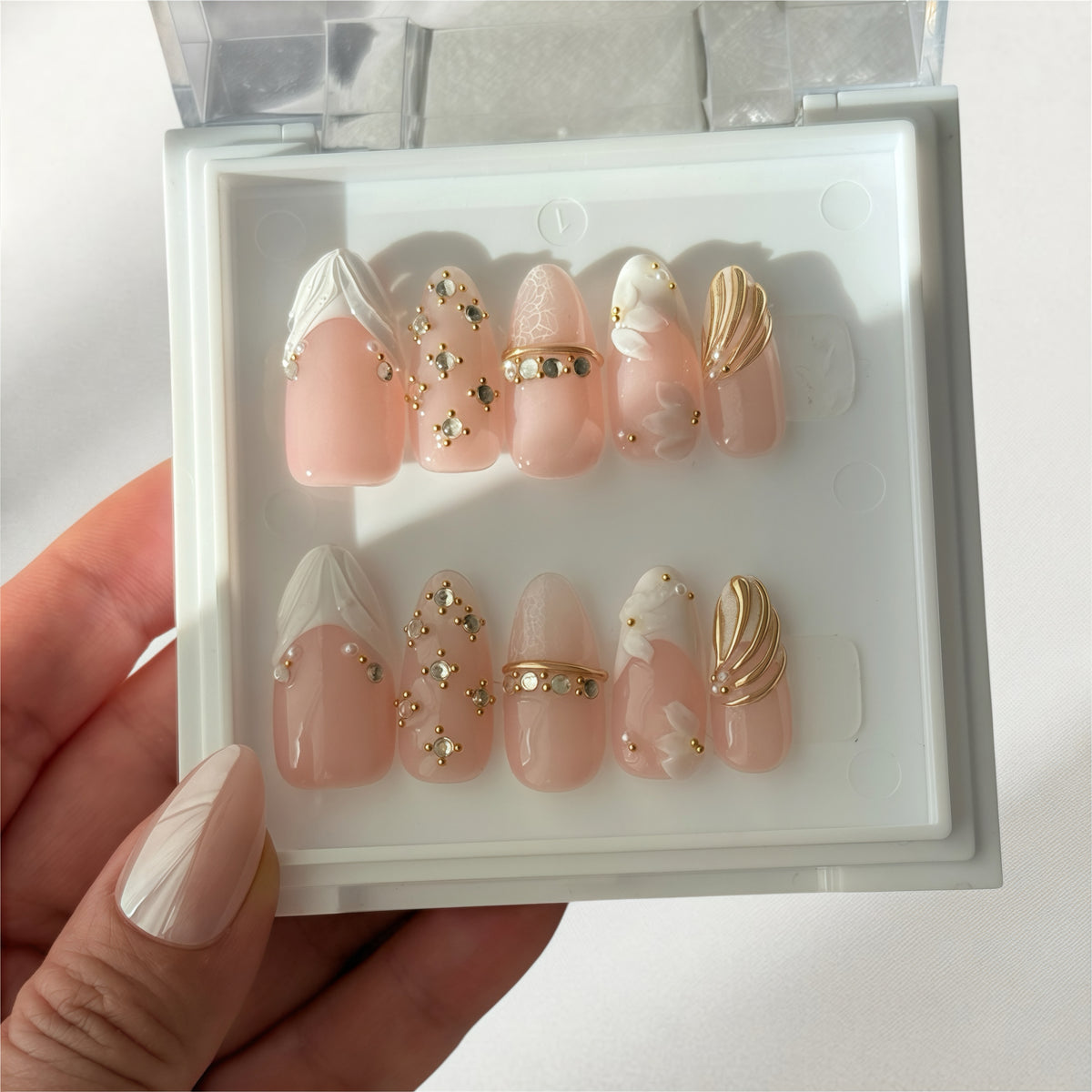 Coromandel Gem 3D nail art close-up, gold shell, white petals and rhinestones, Clarity Club NZ