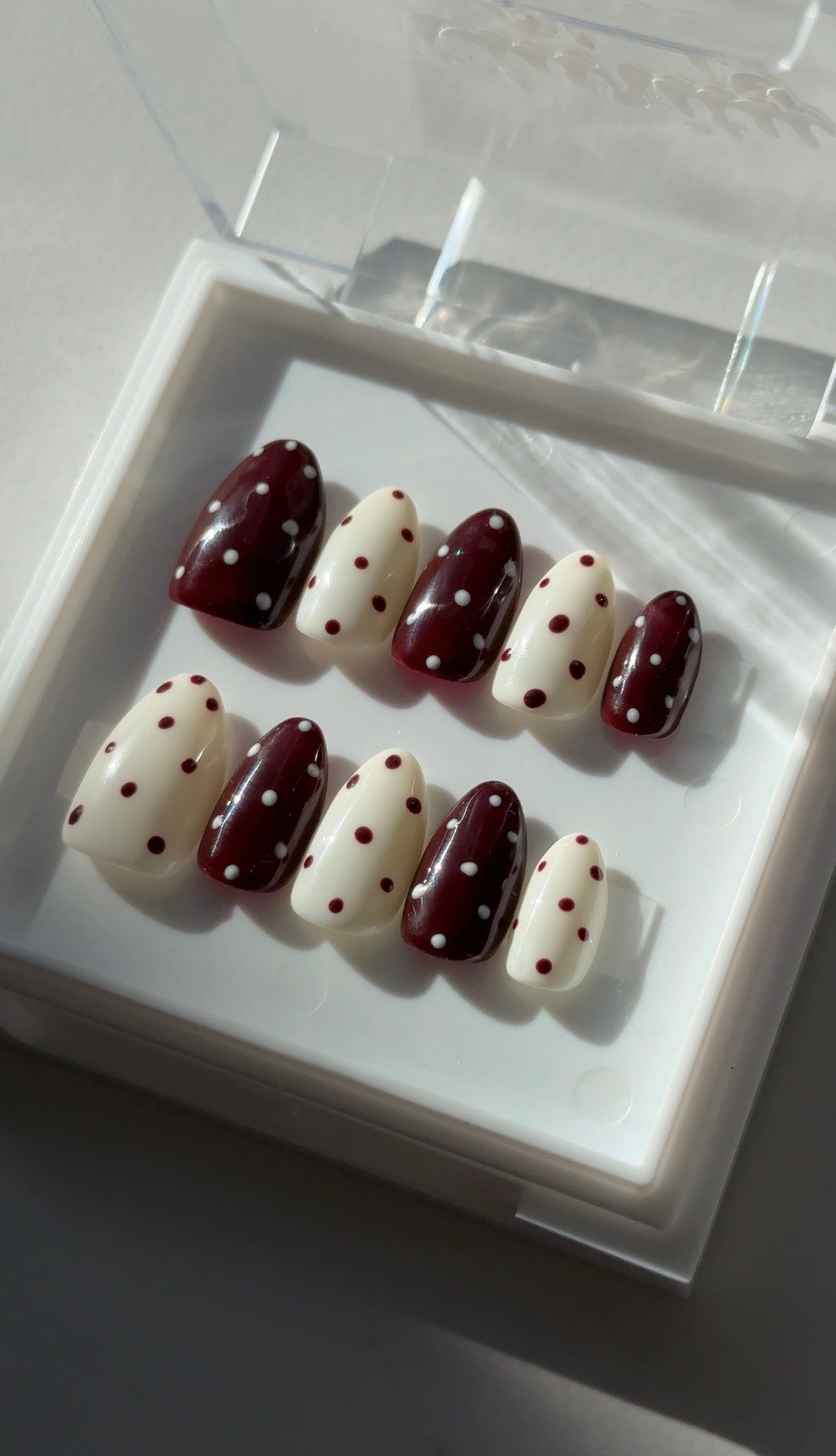 Choco Dots almond press on nails worn on hand, Clarity Club NZ